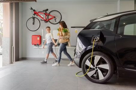 Family in garage with charging car